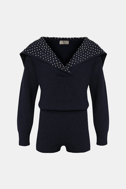 Navy blue outfit with studded collar on a light gray background